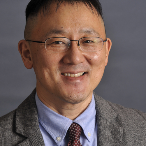 Headshot of Asian man wearing glasses and a tie.